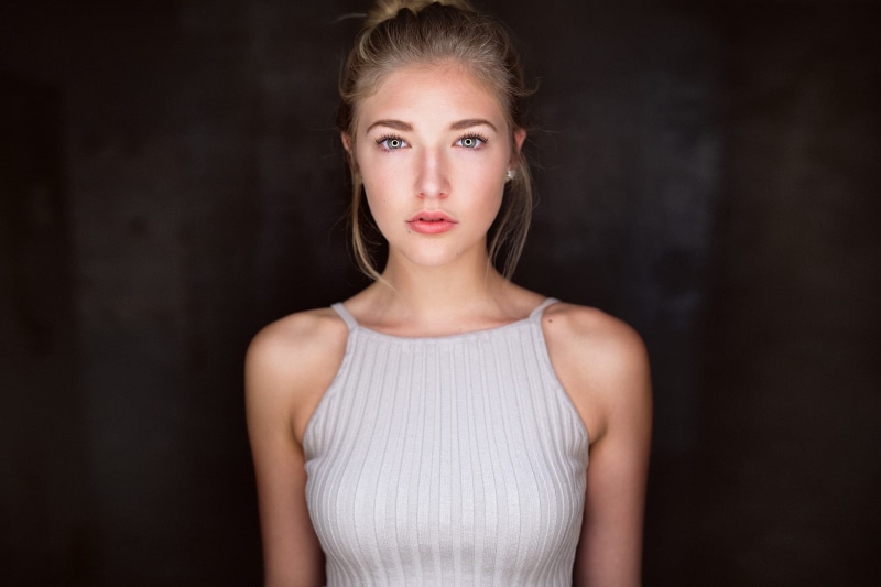 portrait, looking at camera, studio shot, bare shoulders, black background, beauty, contemplation, waist up, blond hair, front view, blonde, beautiful people