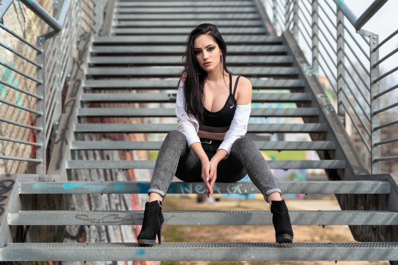 jeans, long hair, model, pink lipstick, women, 2K, short tops, women outdoors, depth of field, sitting, Luigi Malanetto, heels, looking at viewer, eyeliner