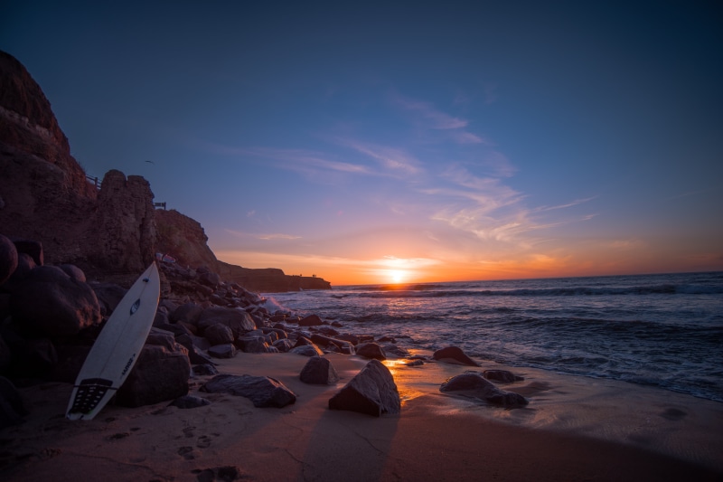 near, light  sky  blue, ob, Diego, 5K, Surf, surfer, white, board, San, coastline, clouds, rock, golden  hour, sea, SUnset, yellow  sun, west  coast, rock - Object