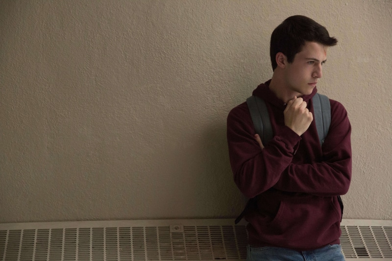 hd, males, casual clothing, 5k, looking, one person, contemplation, tv shows, wall - building feature, 4k, standing, front view, men, 13 reasons why, indoors