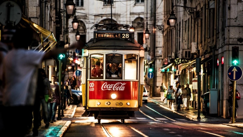 incidental people, city street, public transport, outdoors, portugal, cable car, track, on the move, communication, land vehicle, downtown, architecture