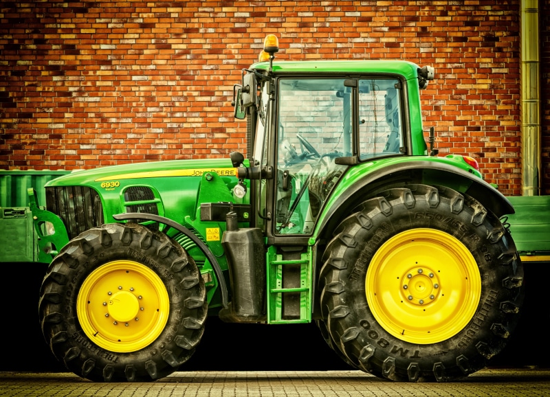 wall - building feature, tractor, day, commercial land vehicle, truck, mode of transportation, all wheel drive, 5K, wheel, rubber, yellow, premium, building exterior