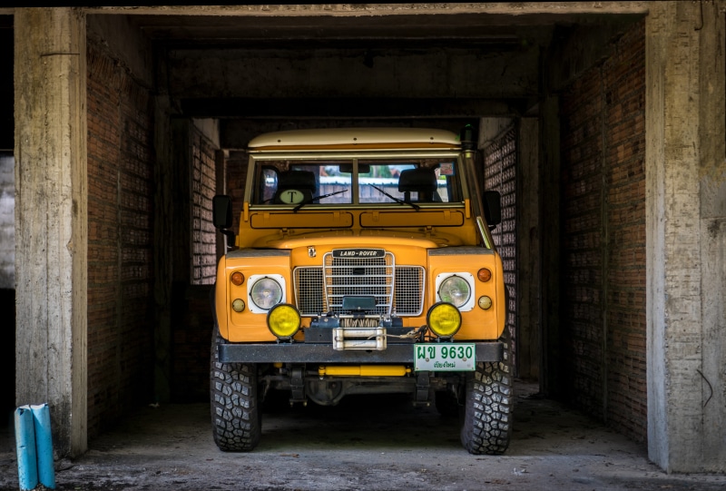 inside, wall - building feature, tire, brown, parked, landrover, wheel, building exterior, retro styled, vehicle, rover, jeep, defender, suv, truck, stationary