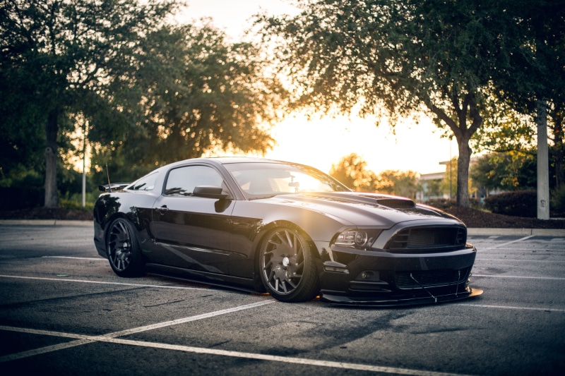 lens flare, plant, sunlight, city, car, mode of Transport, asphalt, near, sports Car, nature, road, luxury, coupe, gt, street, parked, sunset, lowered