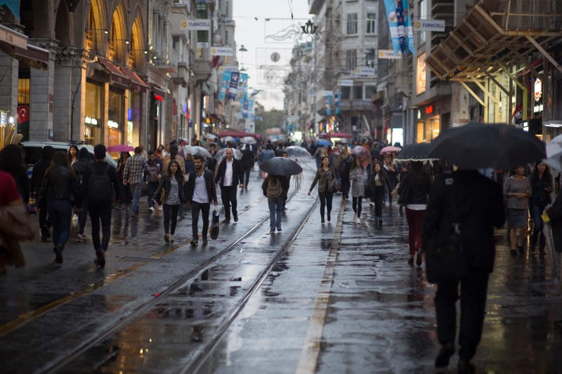 large group of people, rain, wet, street, rainy season, protection, people, buildings, women, real people, city street, walking, crowd, 5K, rainy, adult