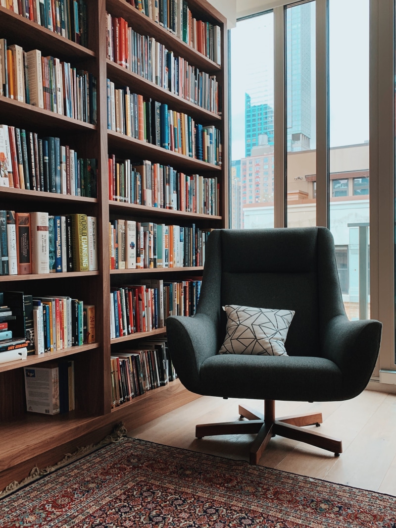 padded, domestic room, books, hardwood, rolling, sofa, absence, fabric, shelf, indoors, floor, no people, publication, gray, flooring, house, seat, armchair