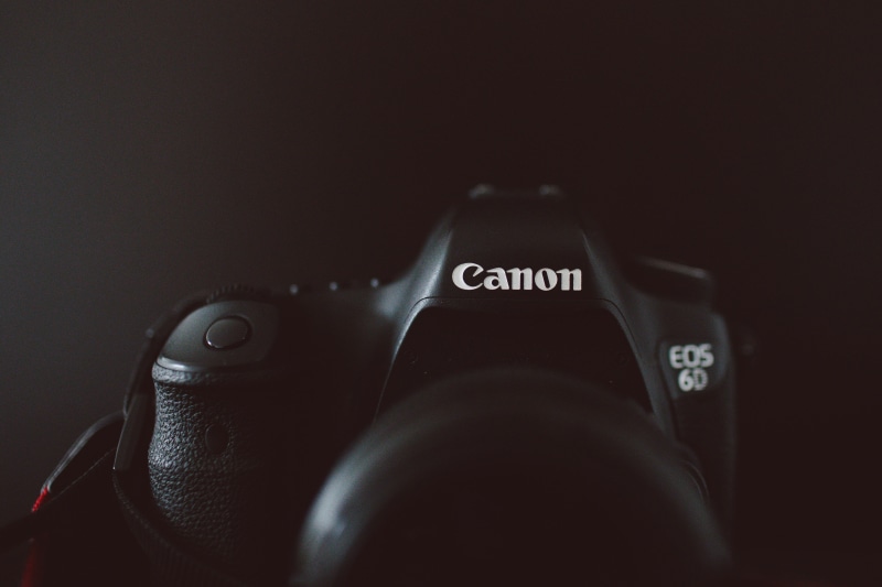 computer part, still life, dslr, western script, finger, camera lens, video camera, close-up, computer, jewelry, display, black color, lens - eye, close