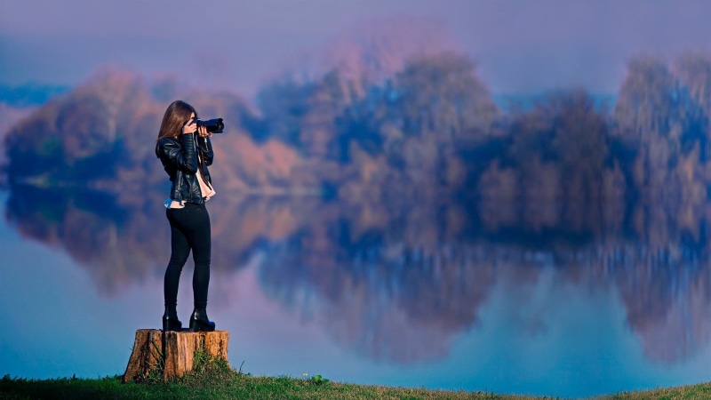 outdoors, patent, sky, photography themes, mountain, one person, cloud - sky, adult, women outdoors, water, looking at view, hairstyle, reflection, focus on foreground