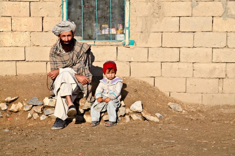 son, clothing, shawl, males, beside, social issues, mature men, man, childhood, boy, adult, plaid, full length, afghanistan, offspring, poverty, family