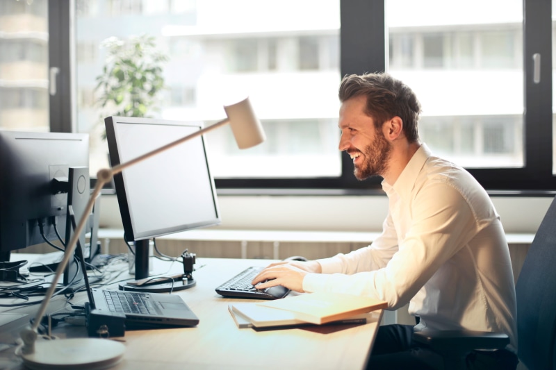 set, wireless technology, using computer, white shirt, laugh, people, technology, joy, black, furniture, digital, notepads, chair, connection, stubble