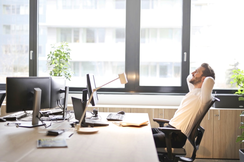 communication, man, behind, black, head, using phone, working, computers, indoor, office, hands behind head, type, caucasian, laugh, furniture, 30-35 years old