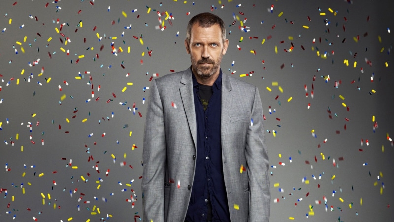 studio shot, waist up, mid adult, emotion, looking at camera, House, success, standing, confetti, 1080P, indoors, one person, gray, men, adult, front view
