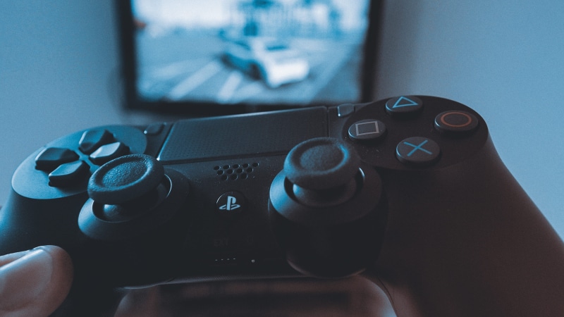 blue, computer, human hand, playstation, hand, technology, game, focus on foreground, telephone, electronics, thumb, controller, human body part, arts culture and entertainment