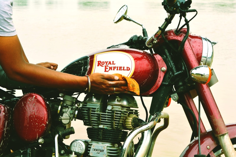 close-up, wash, transportation, wiping, outdoors, hand, motorcycle, bike, indian, enfield, adults only, land vehicle, rider, tourism, royal, retro, real people