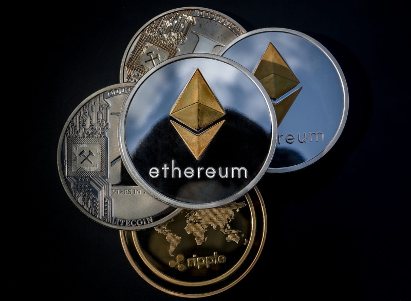 black background, currency, coin, western script, text, asset, digital coin, indoors, payment, exchange, no people, studio shot, silver colored, circle