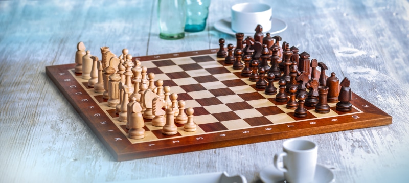 king, pawn - chess piece, playing field, no people, lady, challenge, leisure games, runners, table, indoors, large chess 10x10, intelligence, relaxation