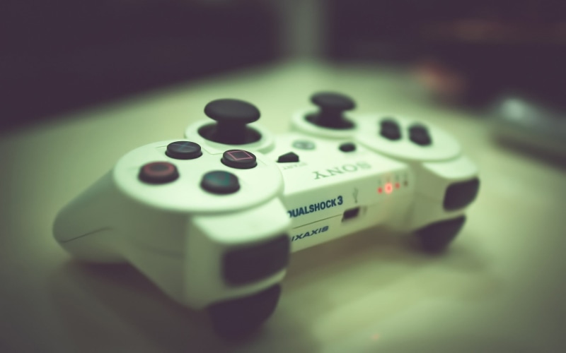 table, toy, still life, number, focus on foreground, remote, remote control, PlayStation 3, high angle view, no people, single object, leisure games, finance