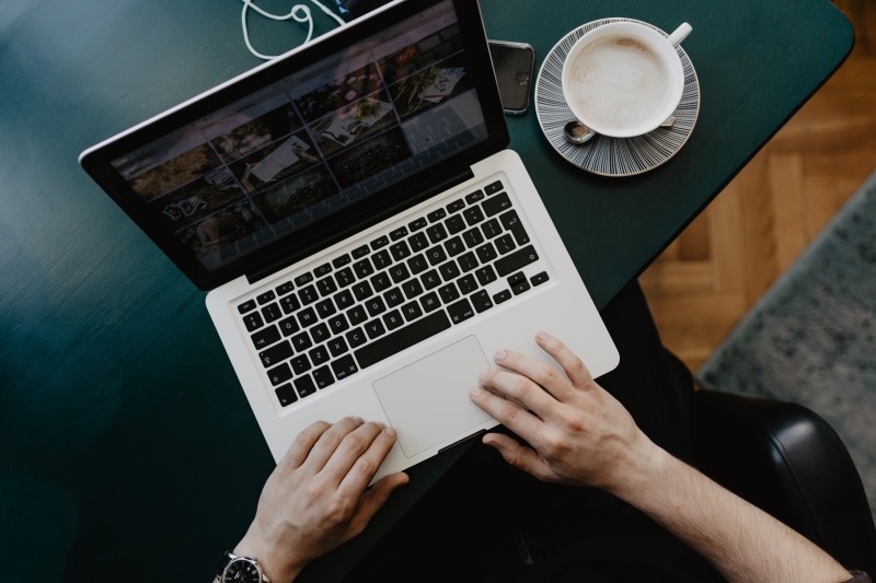 hand, designer, cafe, computer, technology, cappucino, man, table, office, working, laptop, one person, furniture, computer network, coffee, cup, communication