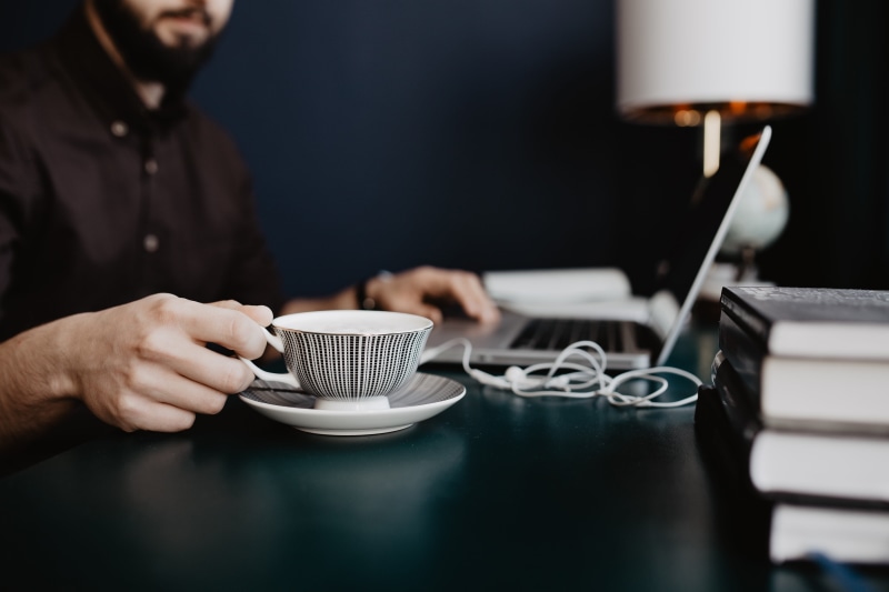 mug, work, office, workplace, designer, table, coffee shop, one person, male, desk, indoors, coffee cup, communication, laptop, workspace, working, computer