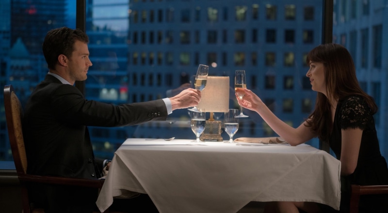 young adult, Dakota Johnson, real people, restaurant, business, table, adult, drink, men, Jamie Dornan, two people, togetherness, food and drink, leisure activity