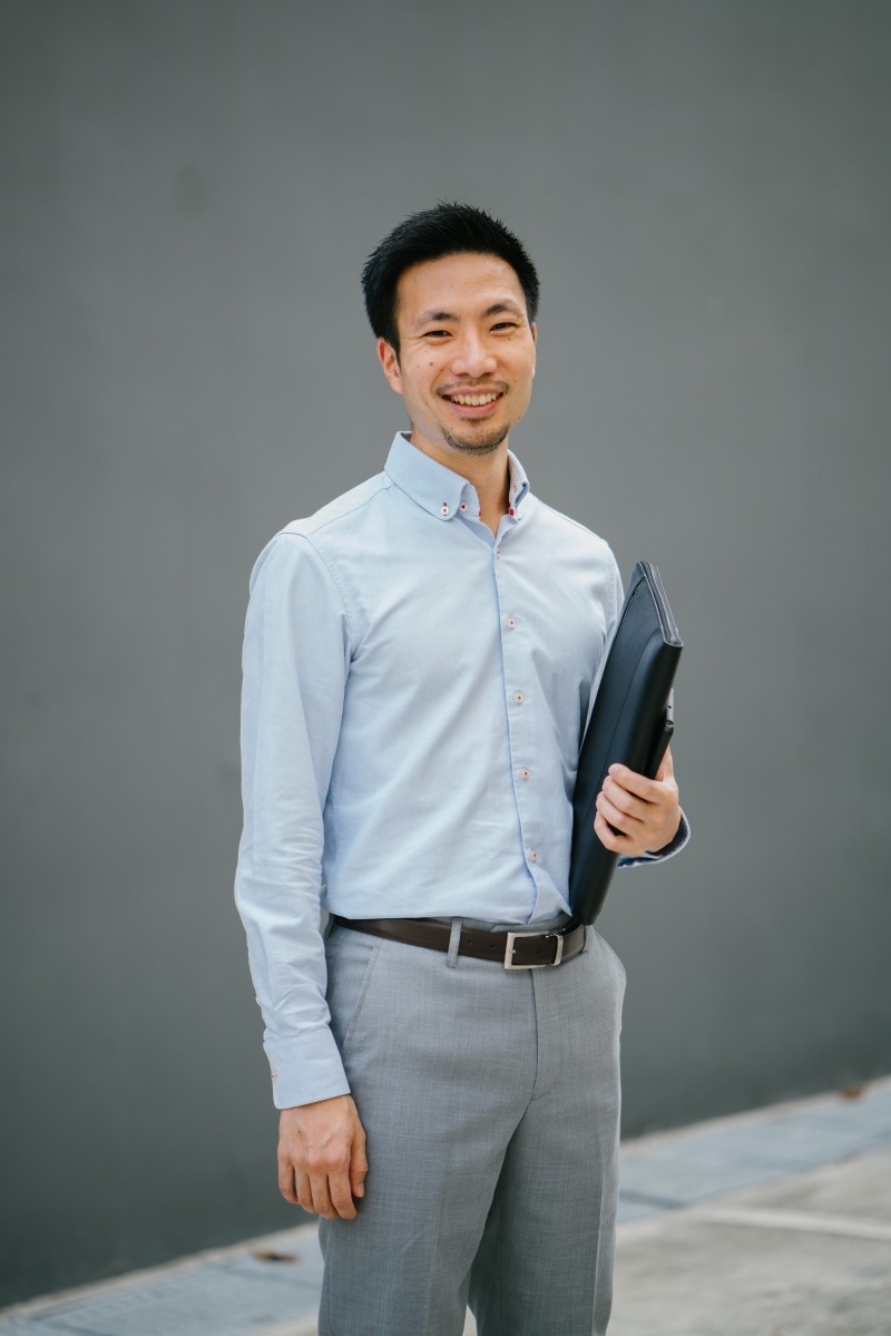 business person, smiling, business, confident, leather, contemporary, men, blue, urban, grey, holding, bag, studio, fine-looking, happiness, work, young