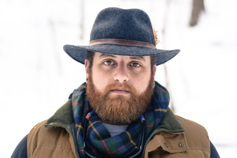 young adult, young, american, body part, face, hat, beard, adult, brown, winter, white, males, looking at camera, mustache, person, ethnic, looking, serious