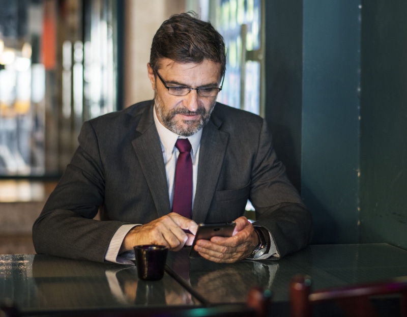 business, table, eyeglasses, jackets, online, suit, men, corporate business, messaging, one person, administration, indoors, 1080P, corporate, front view