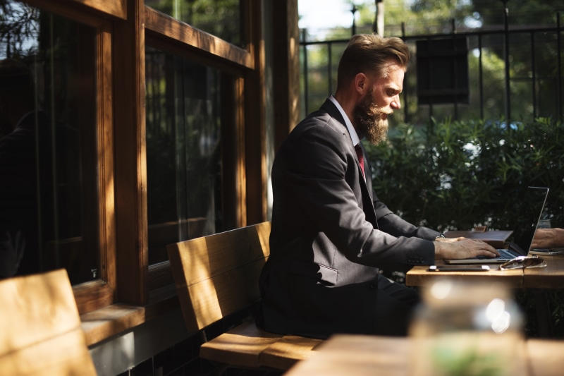 corporate, man, technology, person, internet, typing, wearing, sitting, suit, 5K, beard, only men, one man only, office, males, wooden, table, relaxation