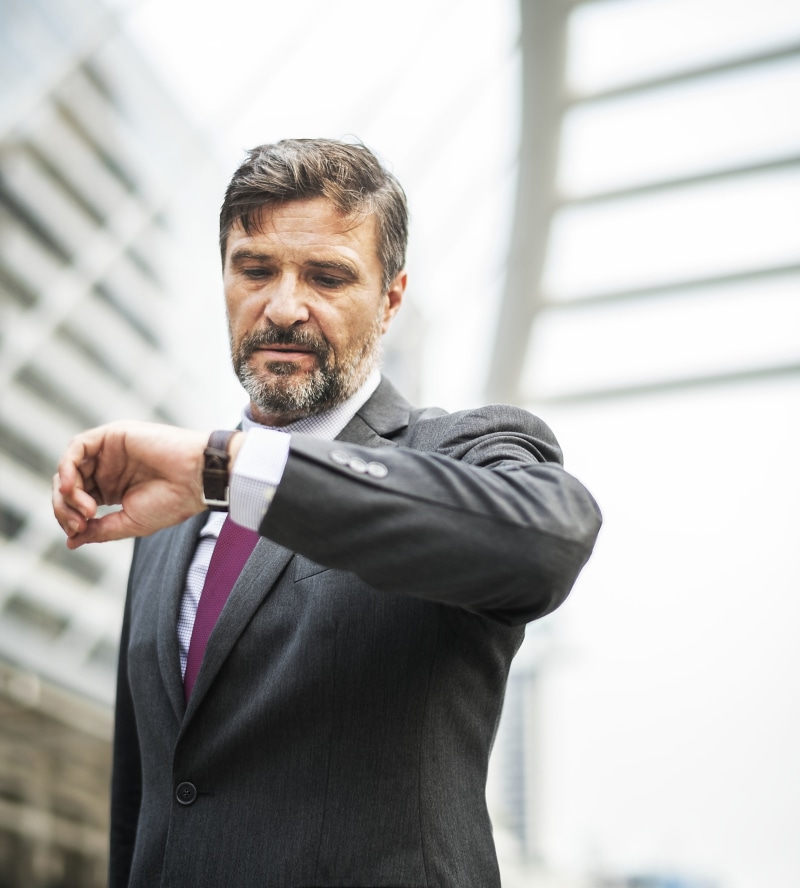 architecture, facial hair, business person, man, businessman, suit, adult, standing, one person, mature men, males, well-dressed, men, checking the time