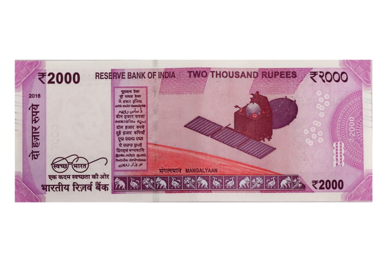currency, envelope, close-up, arts culture and entertainment, studio shot, text, rupee, postage stamp, pink color, indian, human representation, finance
