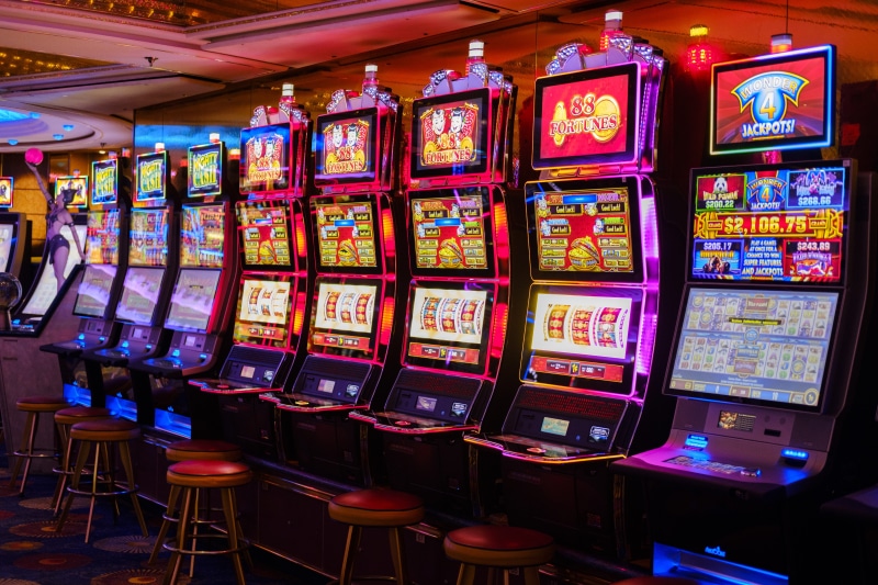 multi colored, seat, opportunity, casino, jackpot, arcade, vending machine, choice, leisure activity, consumerism, large group of objects, retail, in a row