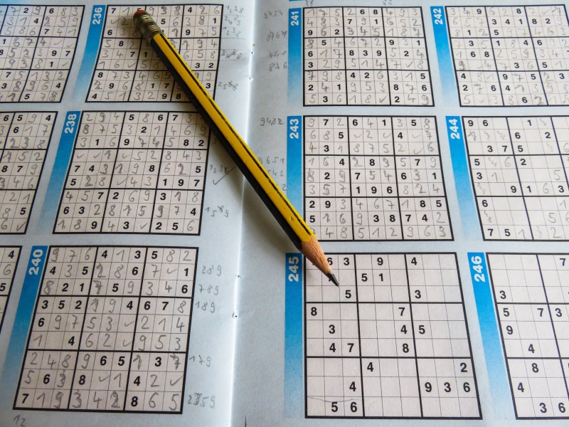 no people, crossword puzzle, text, rates, pay, high angle view, pencil, communication, architecture, 5K, pattern, combination, close-up, leisure, paper