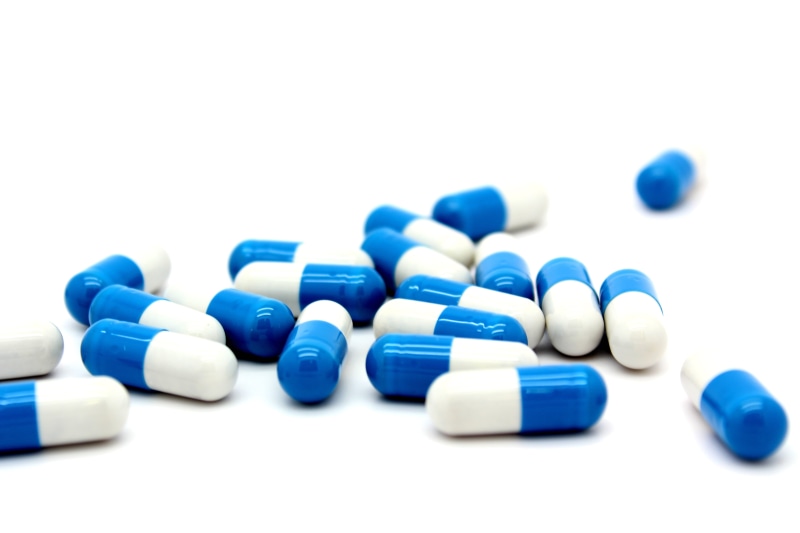 white color, selective focus, indoors, narcotic, no people, white, pill, 5K, studio shot, medicine, vitamin, still life, tablet, blue, large group of objects