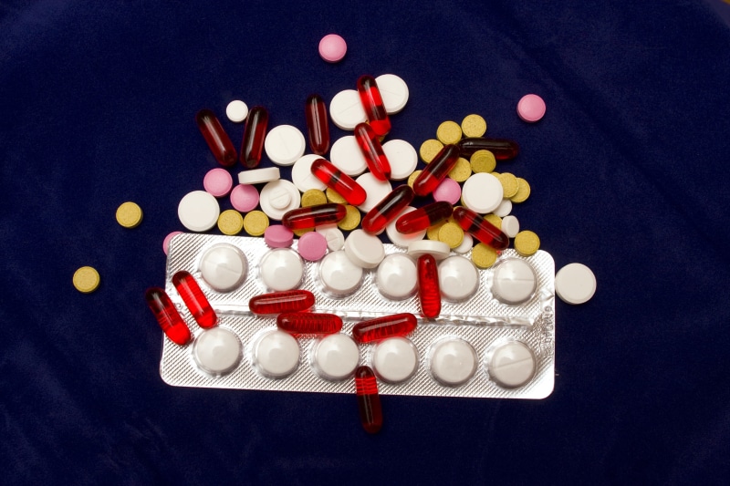 studio shot, 4K, dependency, cure, drug, blue background, pharmacy, red, illness, capsule, isolated, painkiller, medicinal, close-up, medical, no people