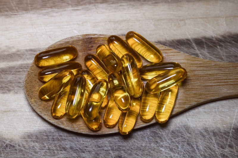 4K, supplement, fish, metal, medicine, gold, pharmaceutical, soft, food, pill, high angle view, studio shot, medication, still life, wooden, liver, table