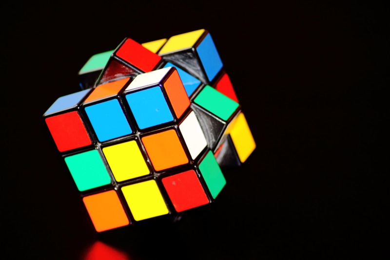 toy block, studio shot, multi colored, black background, rubik, leisure games, black, close-up, indoors, cube shape, magic cube, shape, 3x3, puzzle, block shape