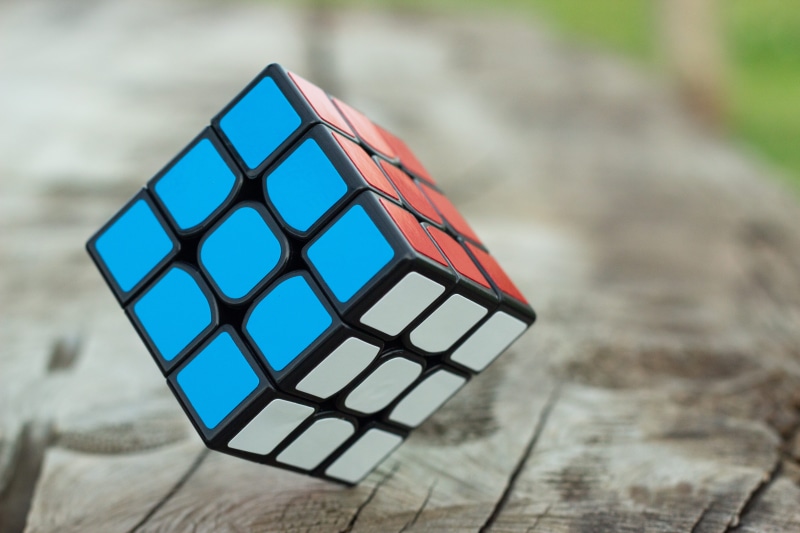 colors, pattern, design, wood - material, rubiks cube, toy, no people, outdoors, nature, day, focus, single object, leisure games, selective focus, high angle view