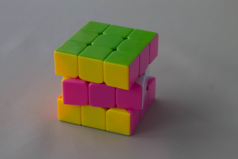 studio shot, abstract, shape, palm, rubiks cube, brain, square, toy, no people, puzzle, geometric shape, multi colored, color, creativity, copy space, cube