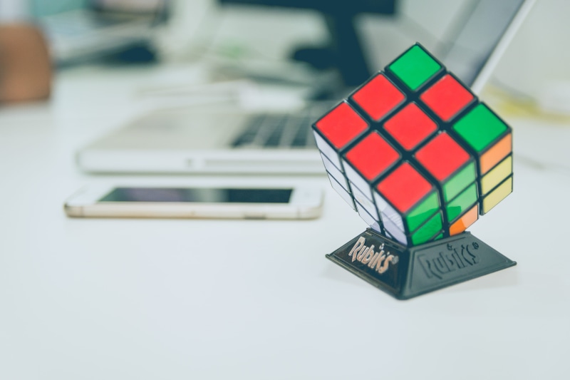 multi colored, desk, focus on foreground, cube shape, close-up, no people, 5K, finance, day, s, education, toy, arts culture and entertainment, white