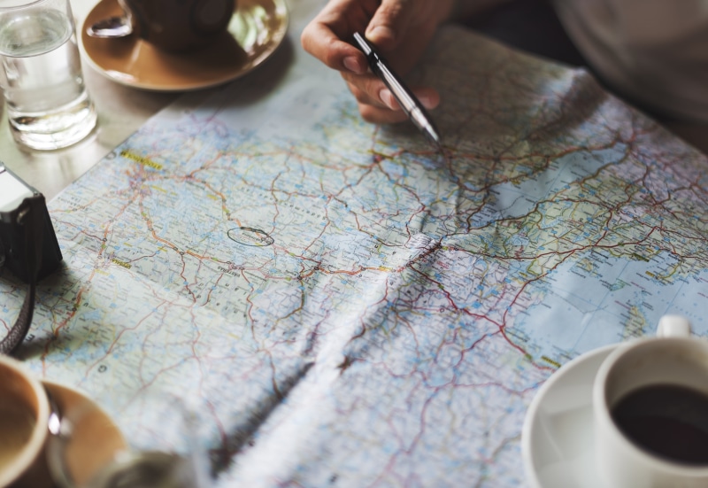 map, destinations, blur, human hand, selective focus, water, people, person, wood, lifestyle, fun, high angle view, writing, recreational, destination