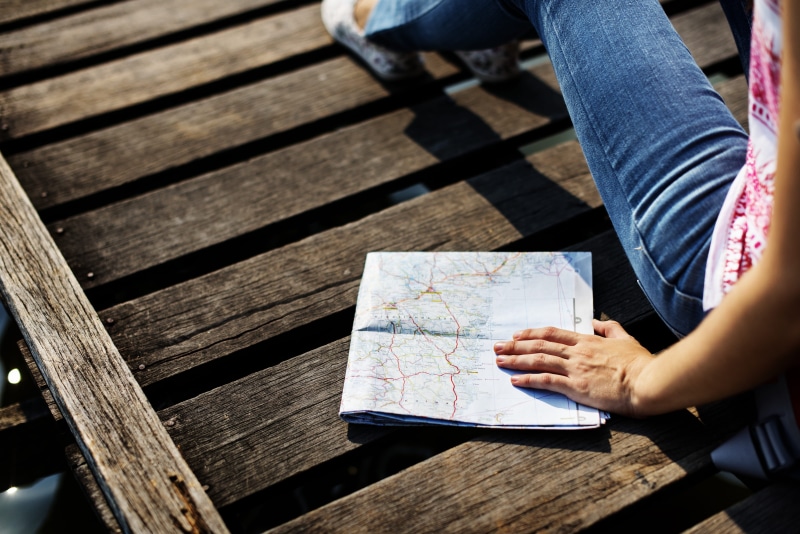 expedition, unrecognizable person, adult, dock, body part, direction, wood - material, route, tourism, shadow, low section, casual clothing, high angle view
