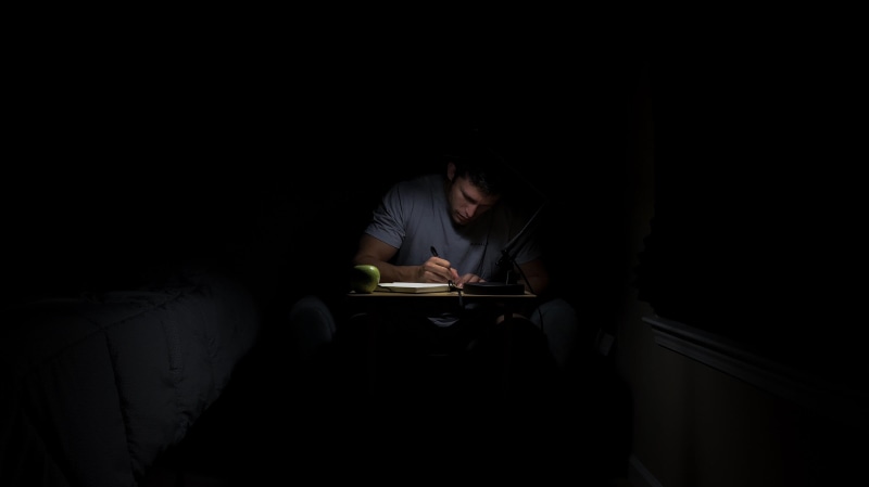 black background, write, learning, reading, publication, night, male, study, indoors, activity, journal, apple, copy space, notebook, one person, room