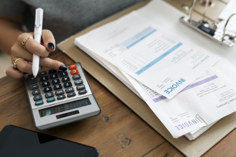 working, workspace, financial, connection, woman, business, invoice, pen, numbers, paper, single, wireless technology, indoors, hand, wood - material, office