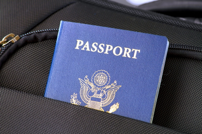 indoors, journey, close-up, mode of transportation, luggage, country, identification, air vehicle, corporate business, passport, government, business, airport