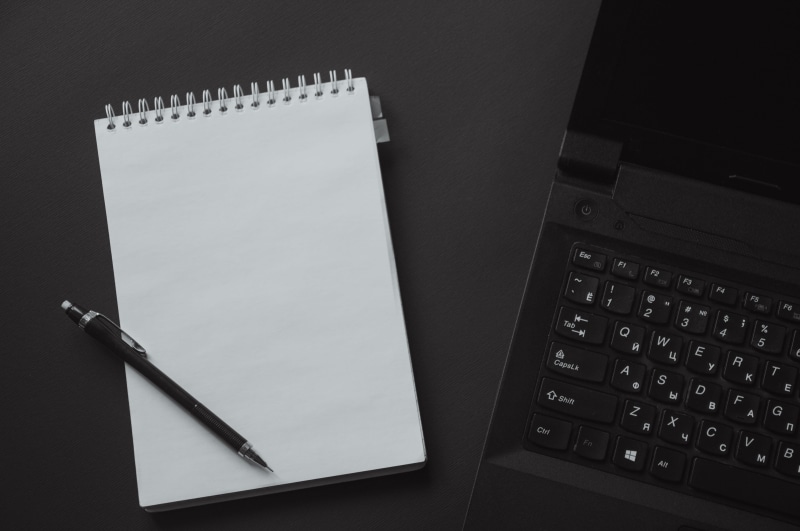 workspace, close-up, pen, communication, notebook, table, paper, black and white, writing instrument, laptop, indoors, publication, directly above, beside