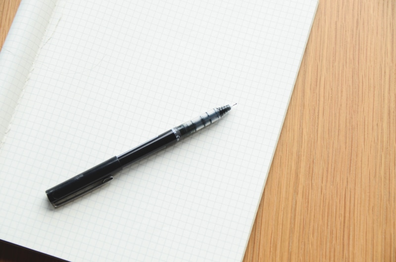 plan, page, no people, wood - material, ballpoint, message, table, white, black, fountain pen, empty, directly above, indoors, two objects, textile, note pad