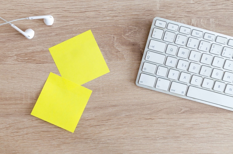indoors, computer key, business, computer equipment, paper, creativity, work, sticky notes, office, computer, earphones, table, top, close-up, reminder