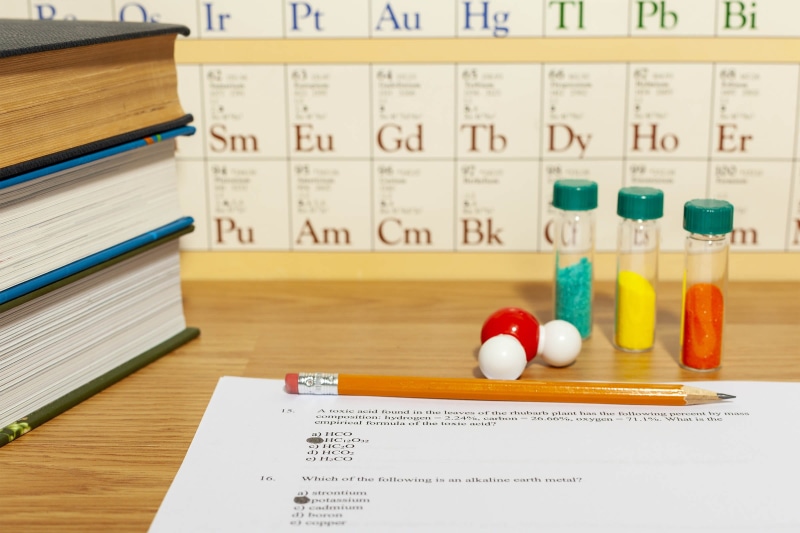 large group of objects, 1080P, pill, wood - material, table, type, studying, questions, writing, number, text, academic, chiooice, prescription medicine