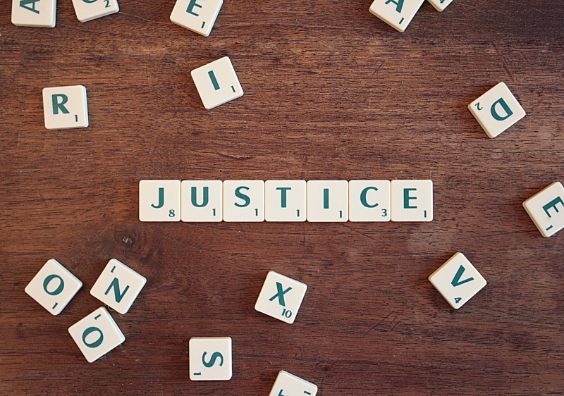 justice, table, letters, word, letter, scrabble, indoors, text, studio shot, right, lawyer, chaos, directly above, legal, law, still life, toy, white color