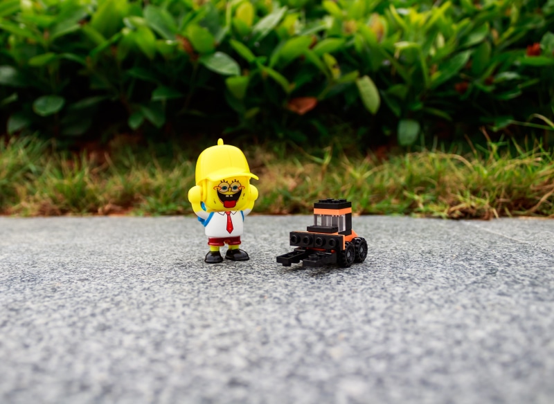 creative, representation, game, males, one person, transportation, building, green color, plastic, outdoors, street, city, play, toddler, selective focus